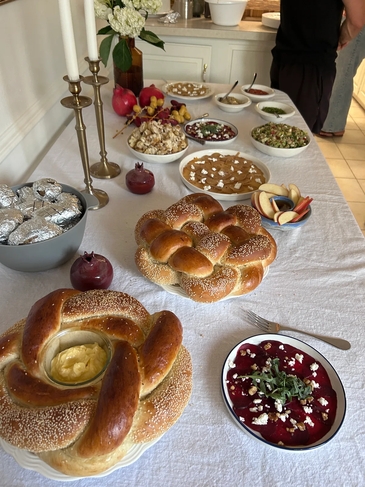 A Shabbat table with challah and candles